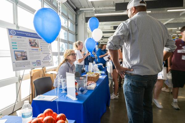 TEK Director, Jennifer Osterhage, PhD, interacts with new students at the 2025 Tech Takeover event. 